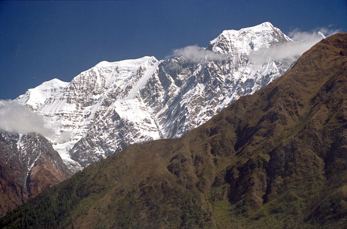 402 Nilgiri North, Central, And South From Lete From Lete, I looked up at a broad snow covered mountain. From left to right Nilgiri North (7061m), Nilgiri Central (6940m) and Nilgiri South (6839m) shone in the early afternoon sun.